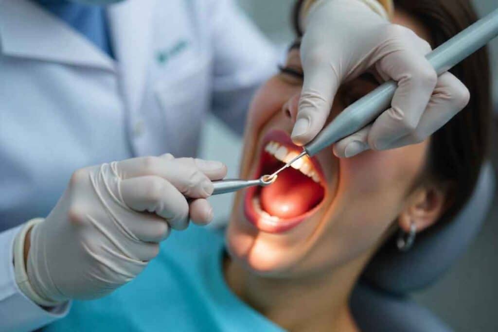 dentist performing a dental filling to treat a cavity in a patient's tooth