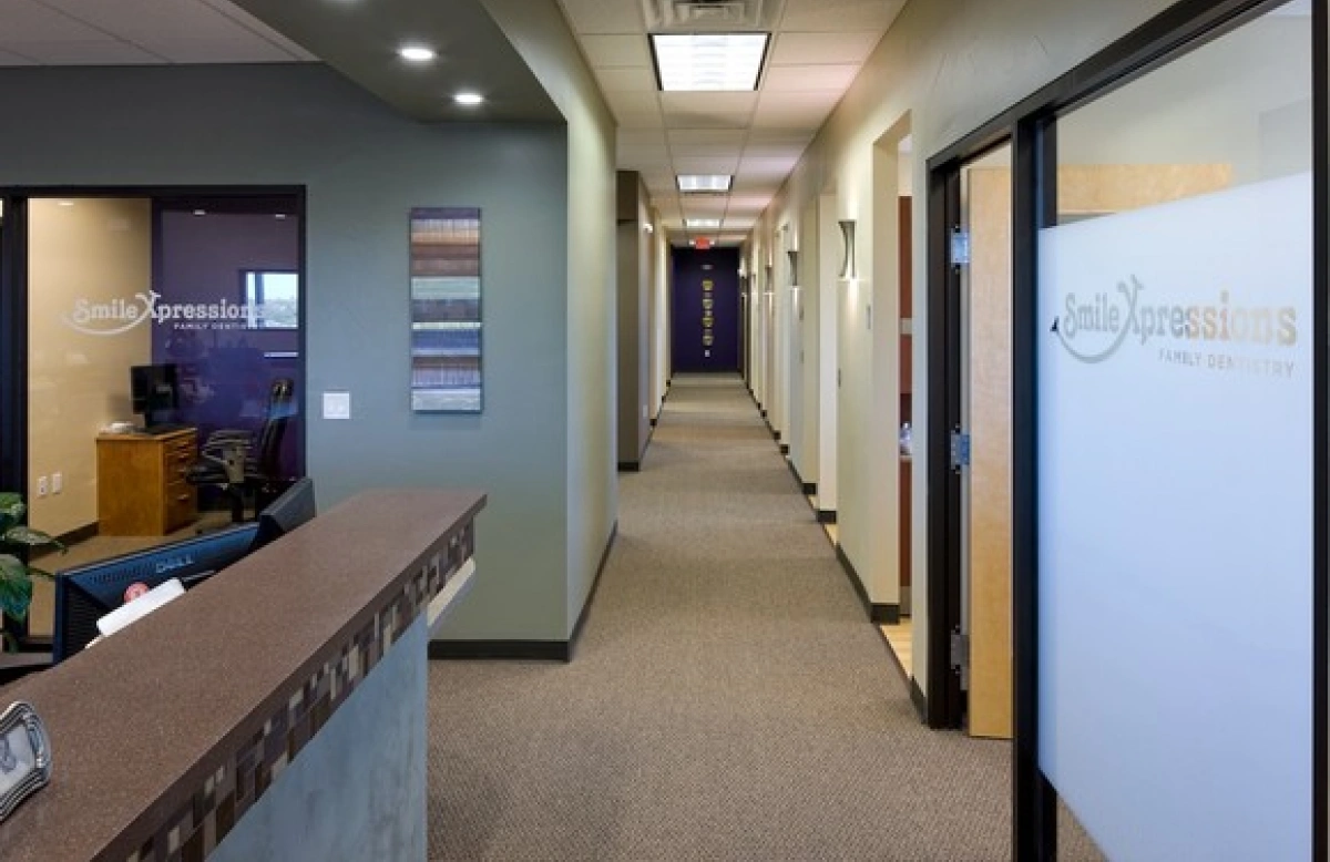 Smile Xpressions Family Dentistry front desk and hallway with glass door signage