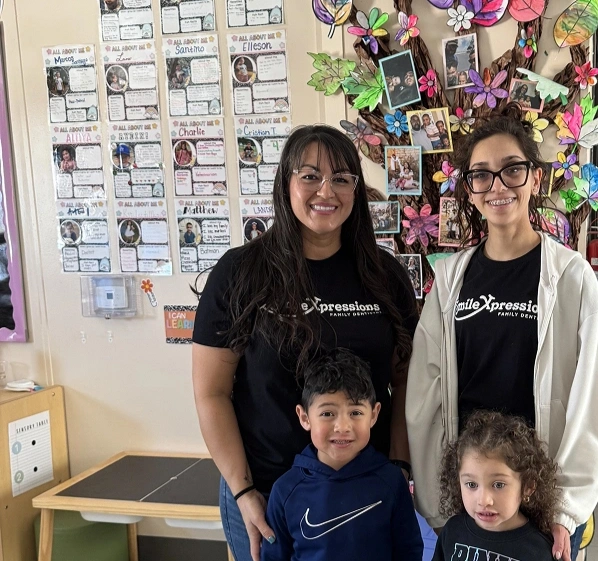 Smile Xpressions Dentistry team members with children at a school event