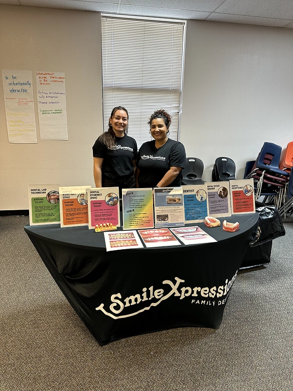 Smile Xpressions Dentistry team members at a career fair booth