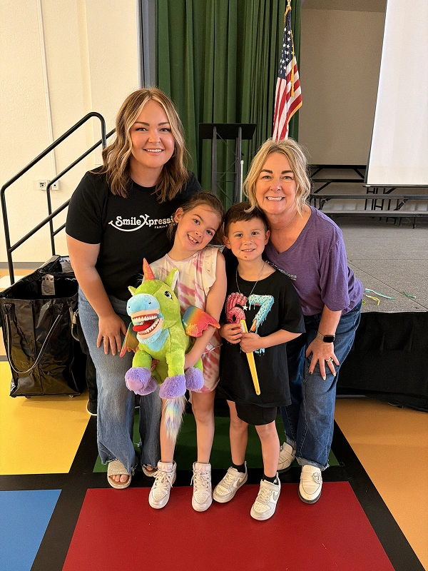 Smile Xpressions Dentistry team members with children at a school celebration