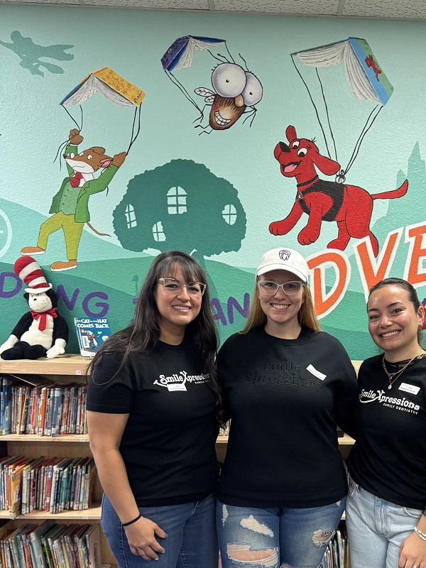 Smile Xpressions Dentistry team members at a school library reading event