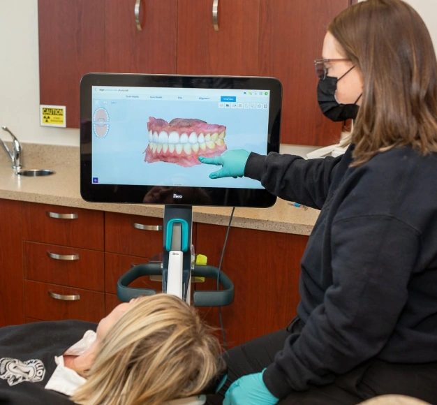Dental hygienist reviewing digital tooth scan with patient at Smile Xpressions Dentistry in Artesia, NM